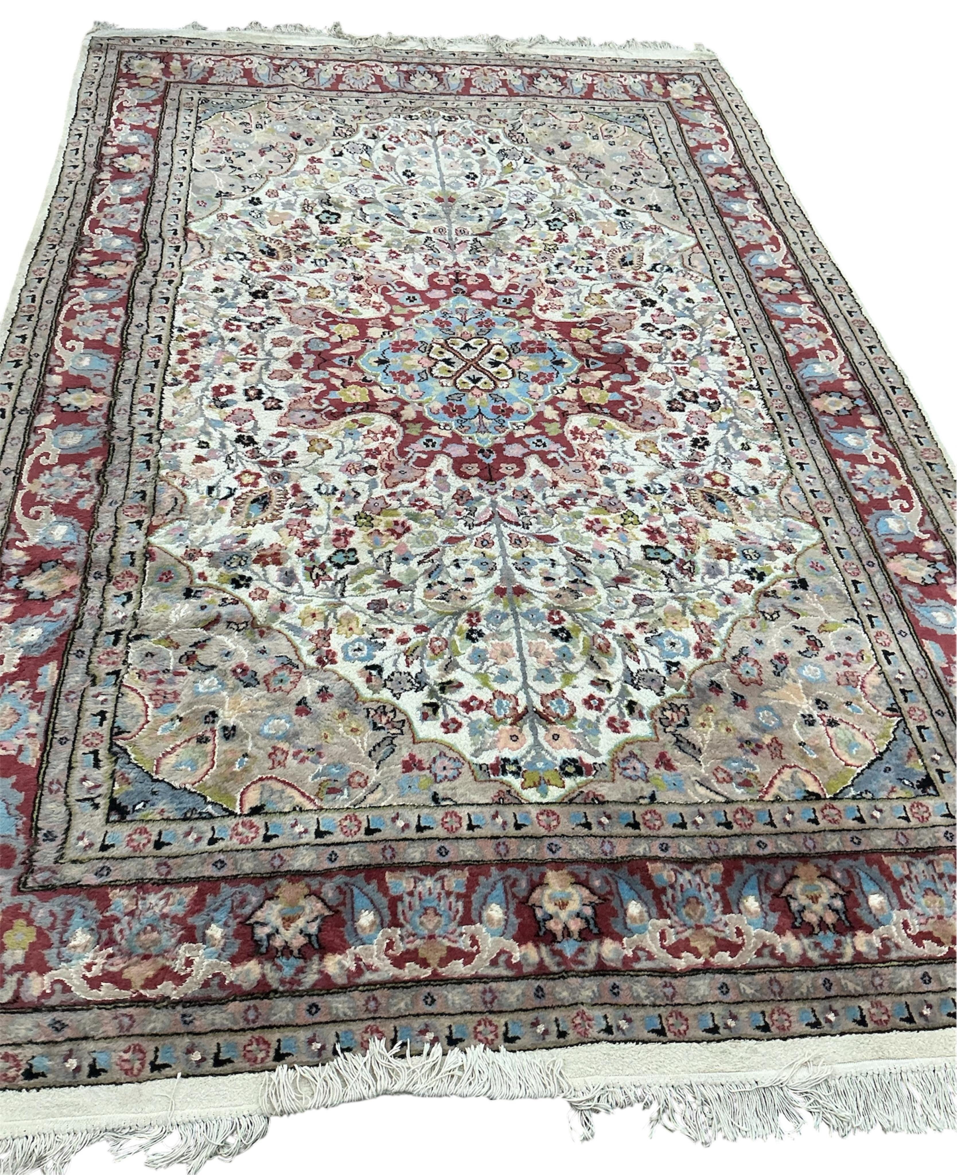 A Pakistan ivory ground part silk medallion carpet, 283 x 192cm